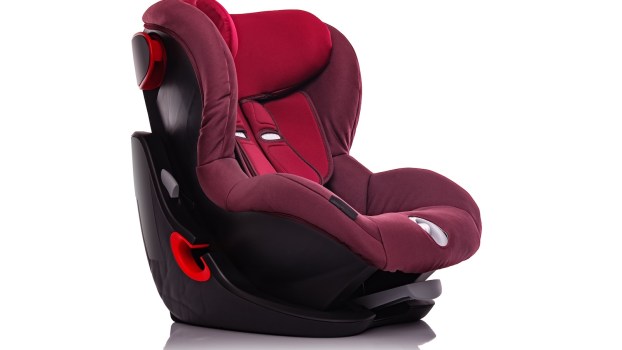 Red child booster car seat on a white background.