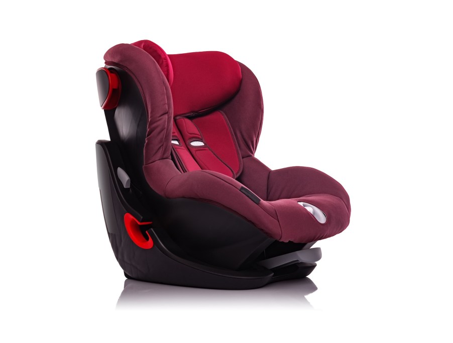 Red child booster car seat on a white background.