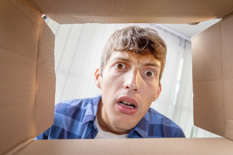 Bahrain customs official's face viewed from inside a box shipped to Navy base
