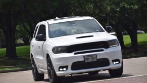 White Dodge Durango SUV parked in front of a row of SUVs.