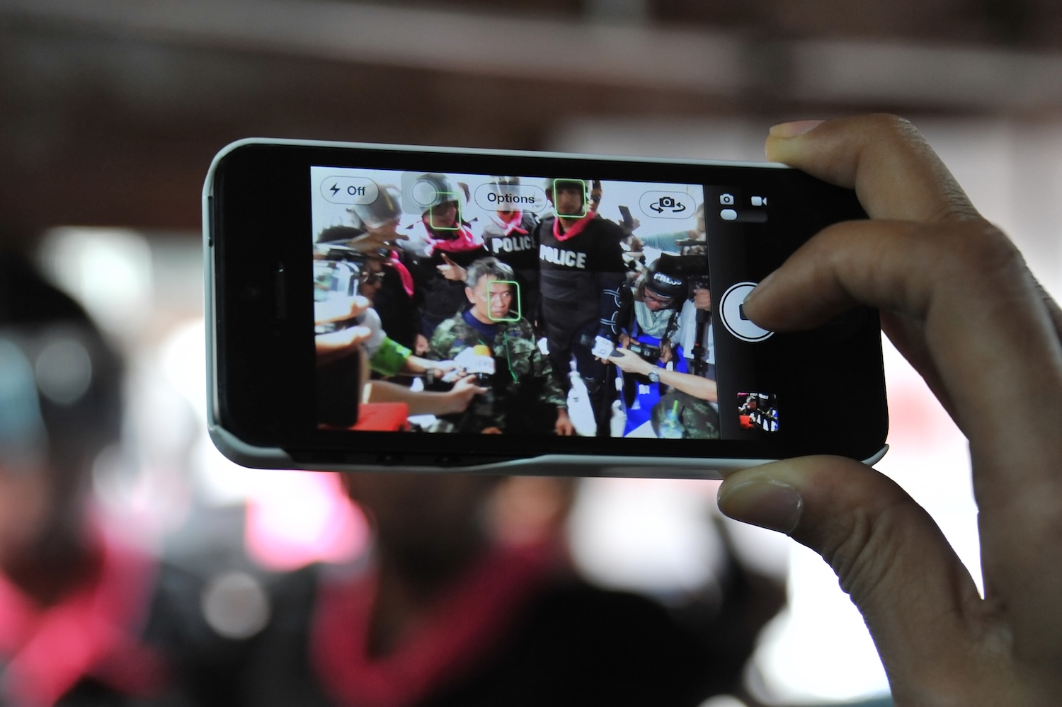 A person filming police officers with a smart phone