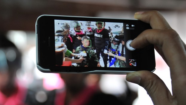 A person filming police officers with a smart phone