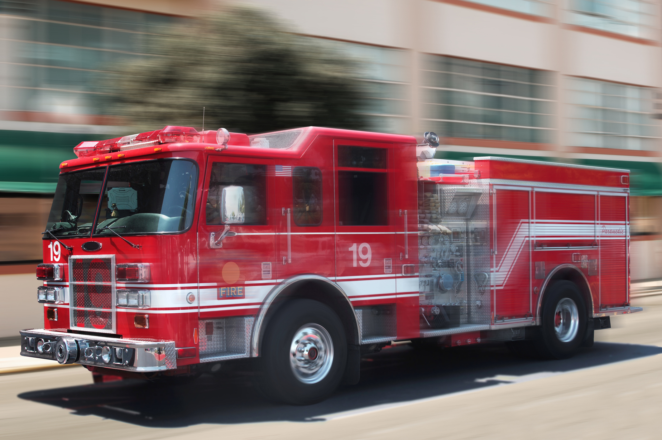 A fire truck speeding down the street
