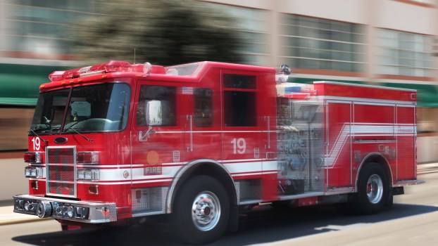 A fire truck speeding down the street