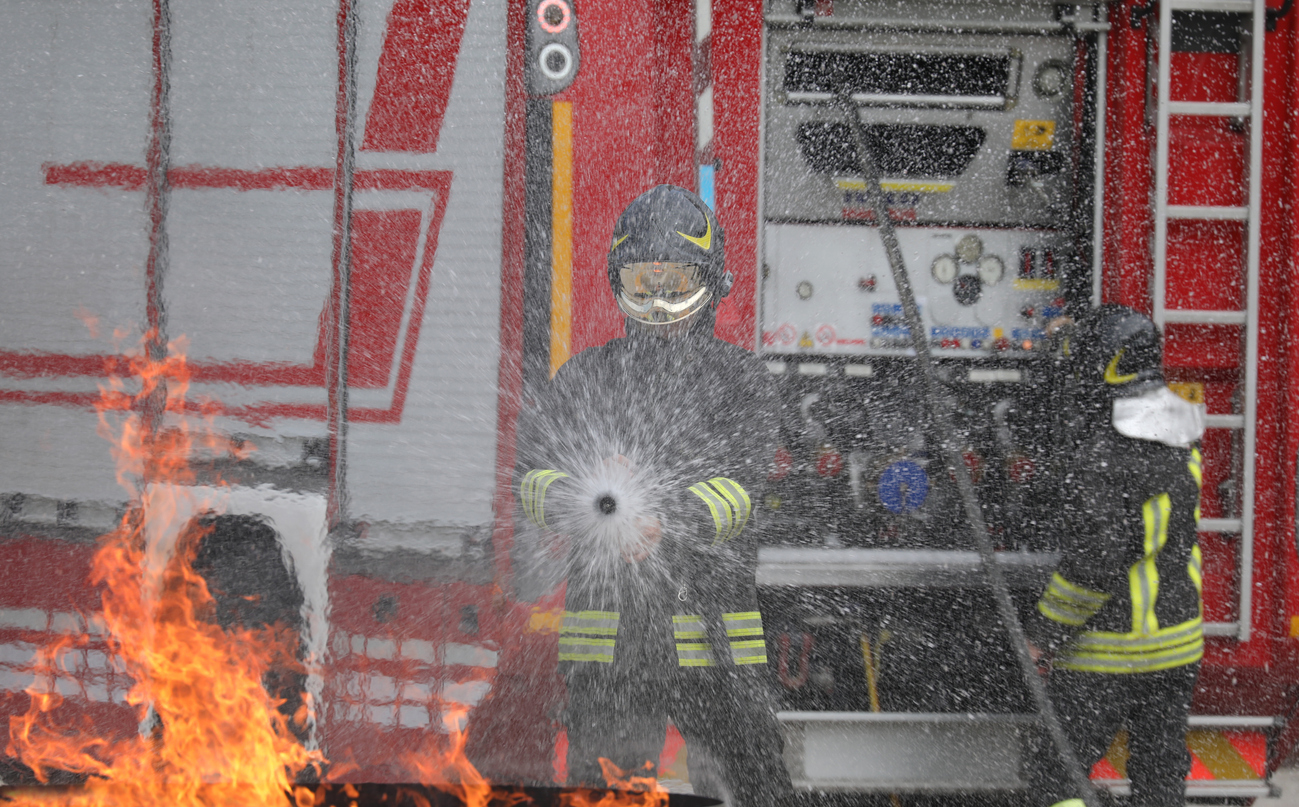 A Firefighter spraying water on a fire