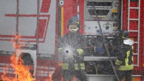 A Firefighter spraying water on a fire