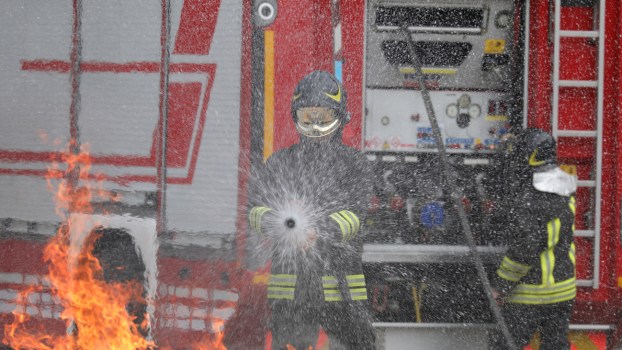 A Firefighter spraying water on a fire