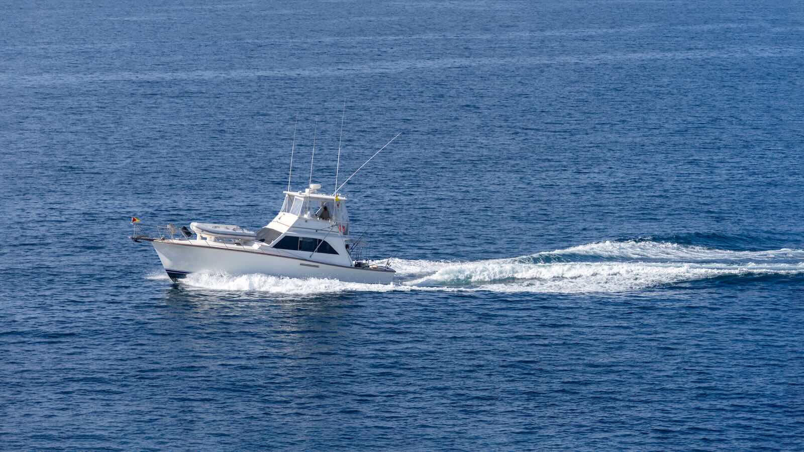 Florida charter captain's fishing boat sailing through the ocean.