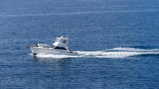 Florida charter captain's fishing boat sailing through the ocean.