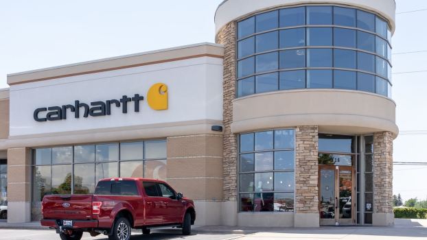 Red Ford F-150 pickup truck parked outside Carhartt store