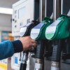 A person grabbing a fuel pump