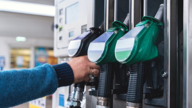 A person grabbing a fuel pump