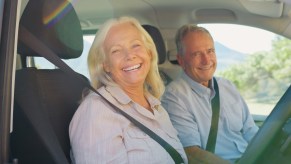 Happy couple driving a reliable crossover.
