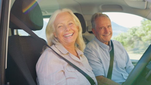 Happy couple driving a reliable crossover.