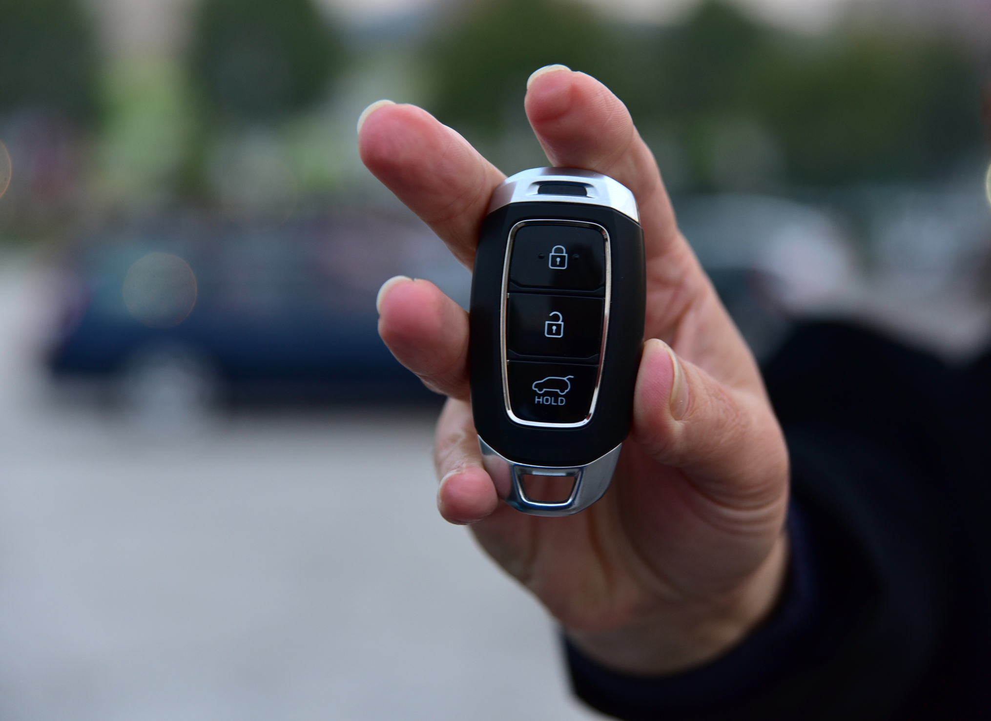 A woman holding a key fob