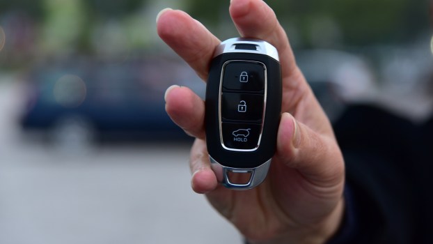 A woman holding a key fob