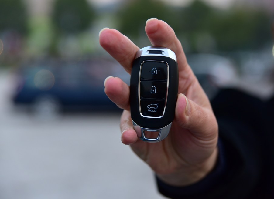A woman holding a key fob