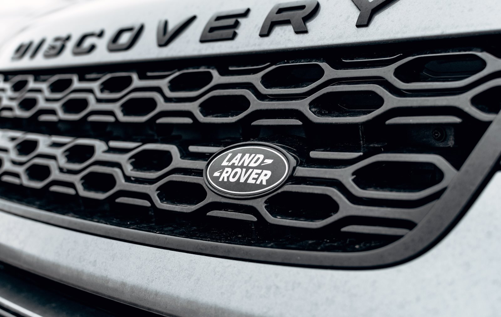 The Land Rover logo on a Discovery SUV grille.