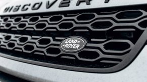 The Land Rover logo on a Discovery SUV grille.