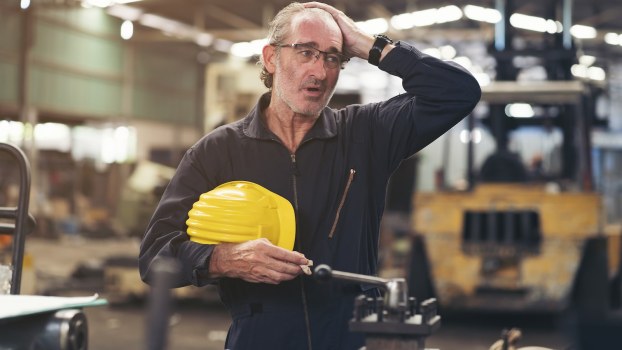 Worker in General Motors' Ohio factory takes off his helmet