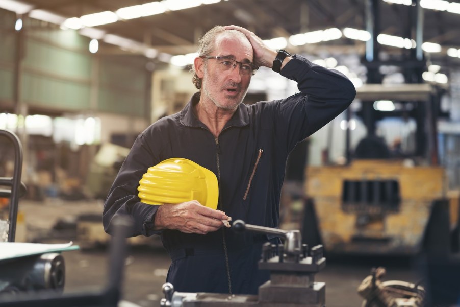 Worker in General Motors' Ohio factory takes off his helmet