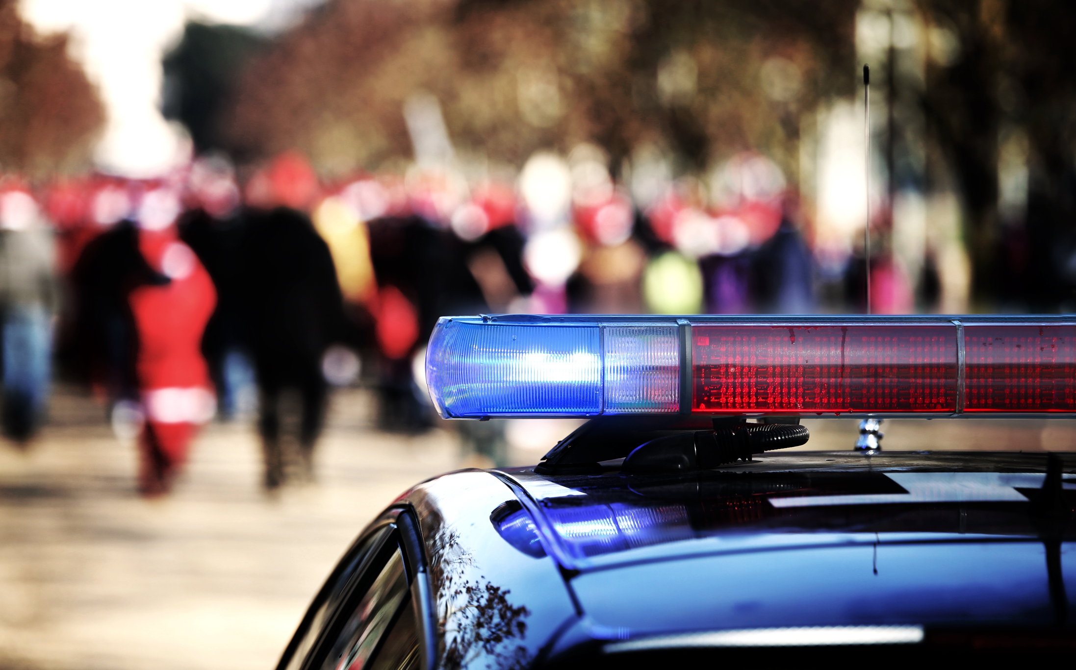 Police lights in front of a crowd