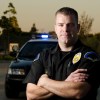 A police officer in front of a car