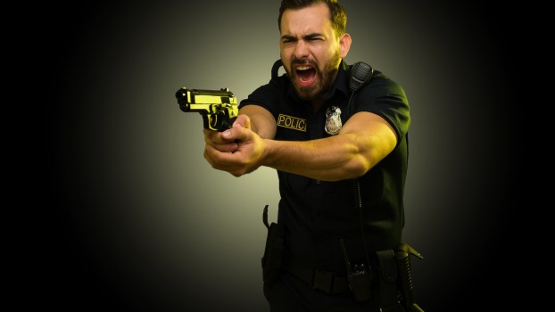 Police officer holding a gun and yelling after car thief backed over his foot.