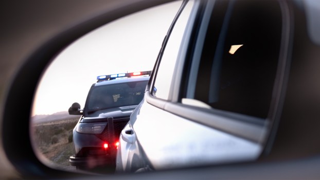 Police-traffic-stop-for-speeding-in-rear-view-mirror