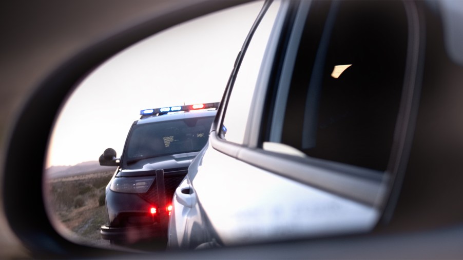 Police-traffic-stop-for-speeding-in-rear-view-mirror