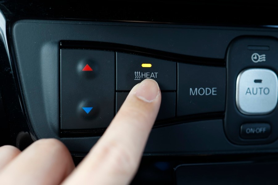 Physical heat button in the interior of a Kia car.