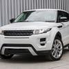 White Ranger Rover Evoque parked in front of a shipping container.