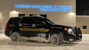 Schoharie County New York Sheriff's Office patrol SUV covered in ice parked in right front angle view
