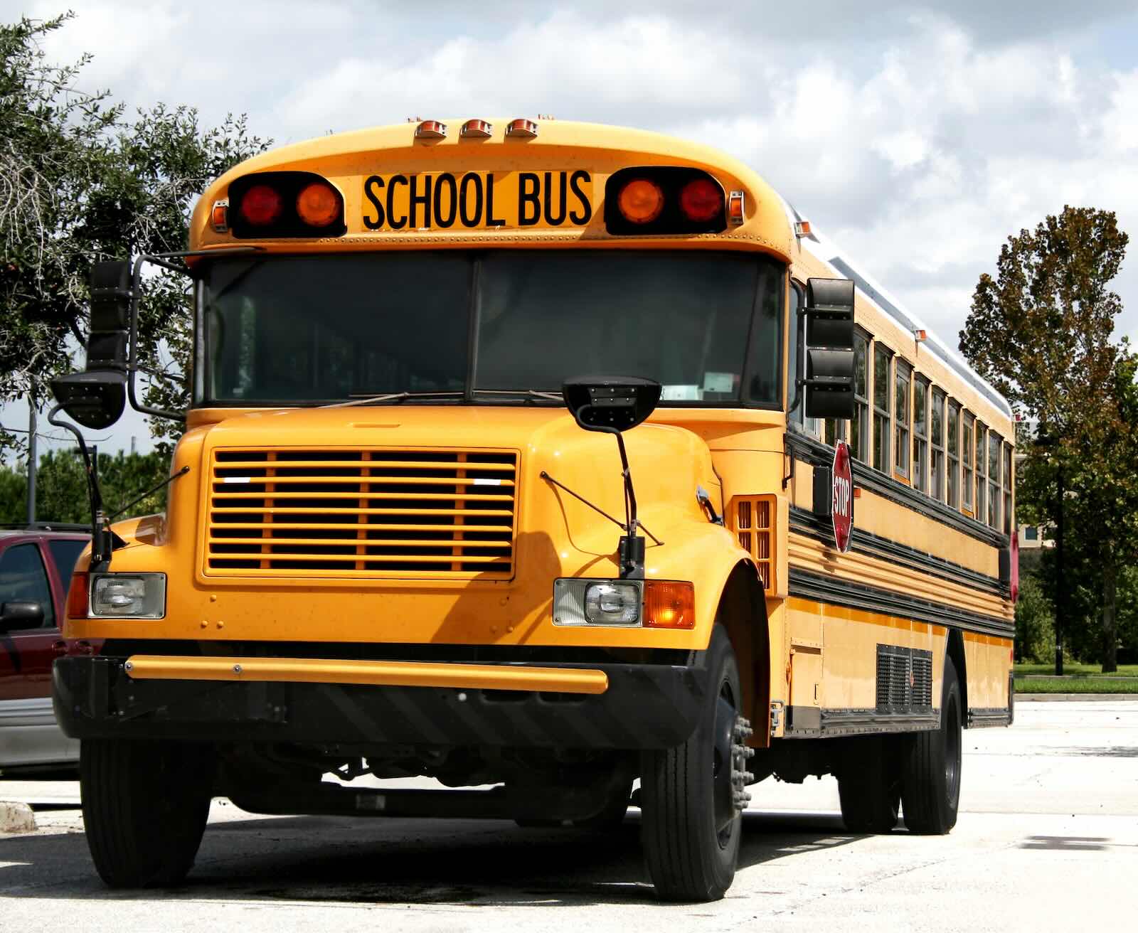 Yellow school bus in parking lot.