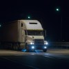 White semi truck on Florida highway at night.