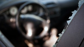 Driver's side car window smashed by ICE border patrol police agents.