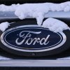 Ford logo on the grille of an SUV or car stuck in snow.