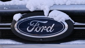 Ford logo on the grille of an SUV or car stuck in snow.
