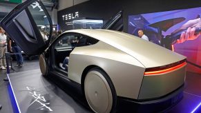 Beige Tesla Cybercab with its gullwing doors open.