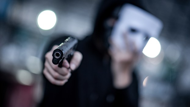 A masked man with a gun