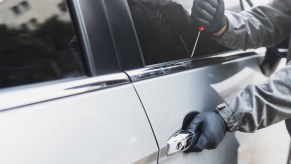 Hands of a thief nabbing a Dodge car