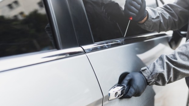 Hands of a thief nabbing a Dodge car