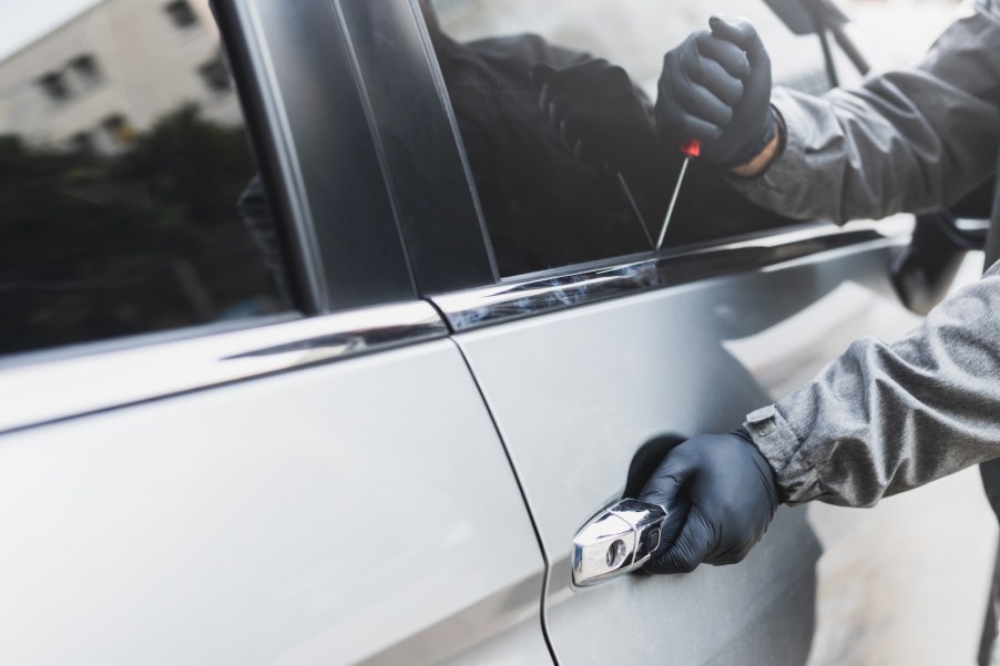 Hands of a thief nabbing a Dodge car