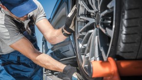 A tow truck operator loading a car