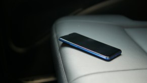A cell phone laying on a car seat