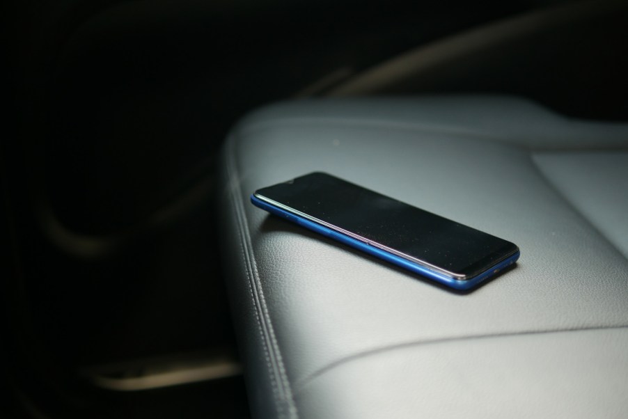 A cell phone laying on a car seat
