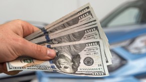 man-handing-over-money-for-new-car