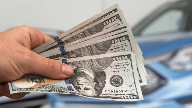 man-handing-over-money-for-new-car