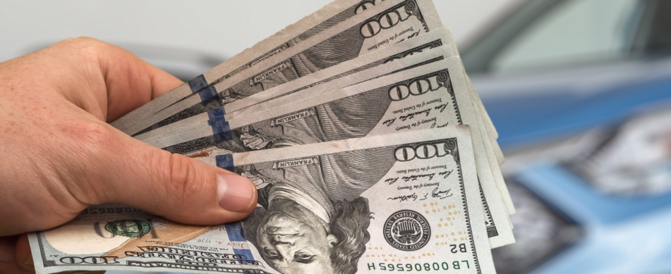 man-handing-over-money-for-new-car