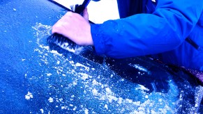 man-scraping-ice-off-car-windshield